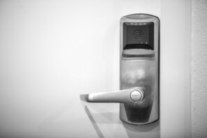 A metallic door handle with a keyhole and a lock mechanism. - Nightcap at Hume Hotel (Yagoona)