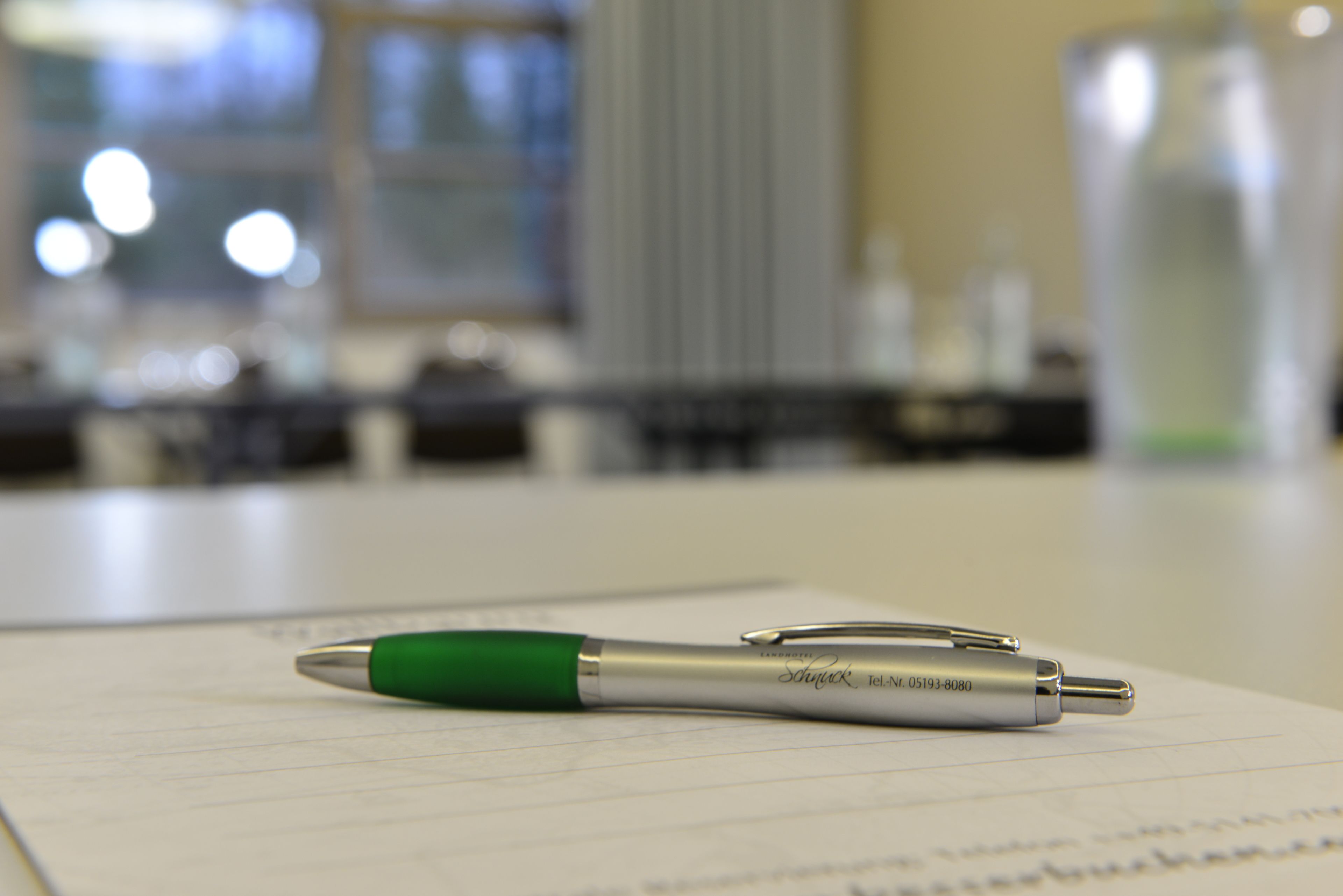A pen on a piece of paper in an indoor setting.