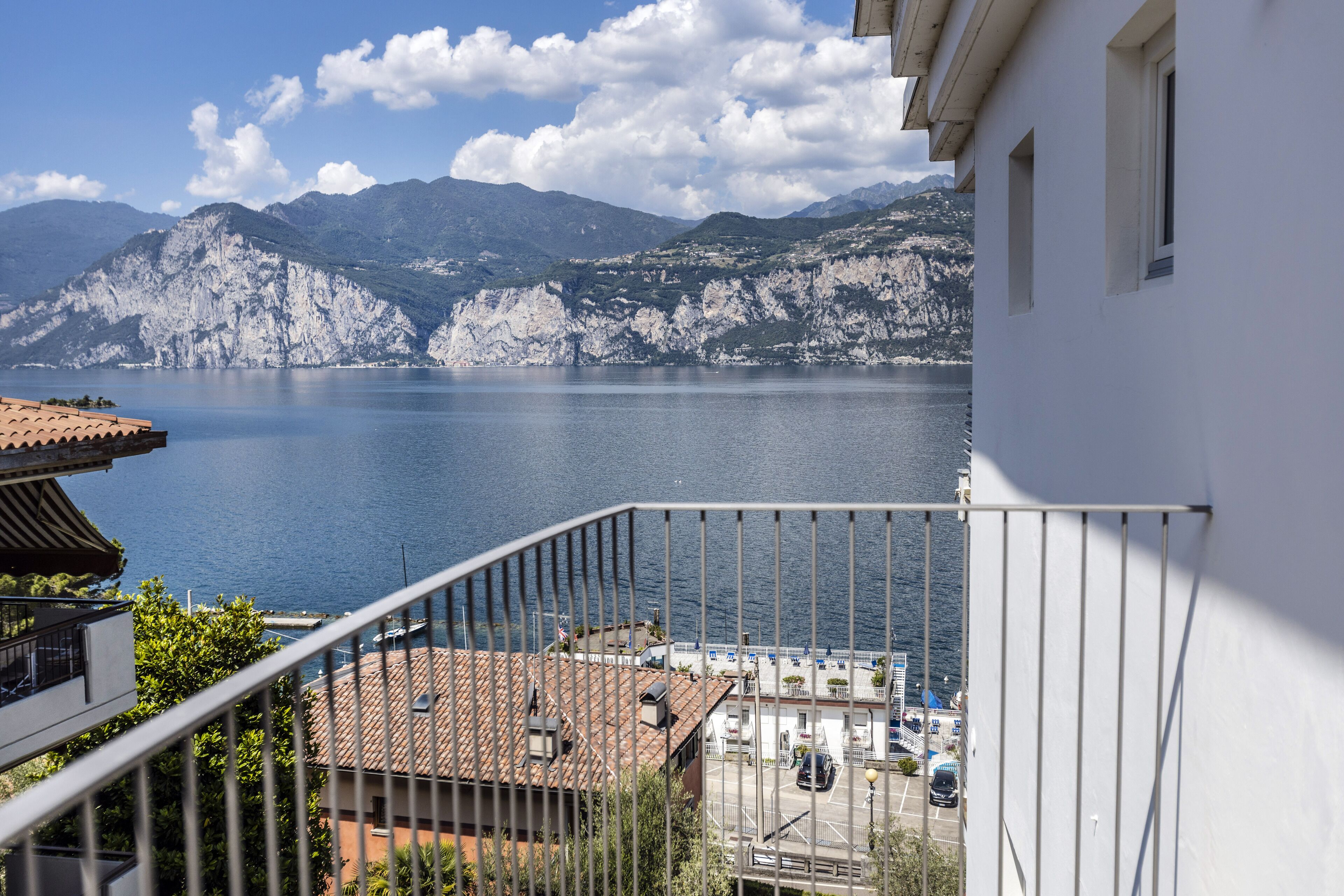 A balcony with a view of a lake and mountains.