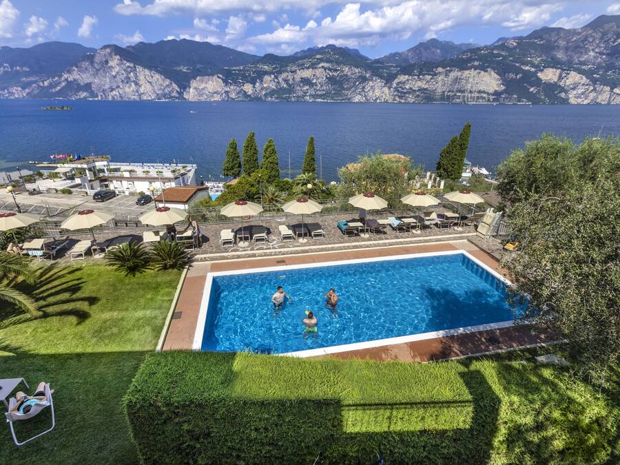 A swimming pool with a view of mountains and the sea.