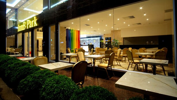 An InnB Park restaurant with outdoor seating and a modern interior. - InnB Park Hotel (Kuala Lumpur)