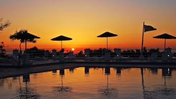 Outdoor pool, open 9:00 AM to 8:00 PM, pool umbrellas, pool loungers