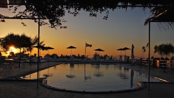 Outdoor pool, open 9:00 AM to 8:00 PM, pool umbrellas, pool loungers