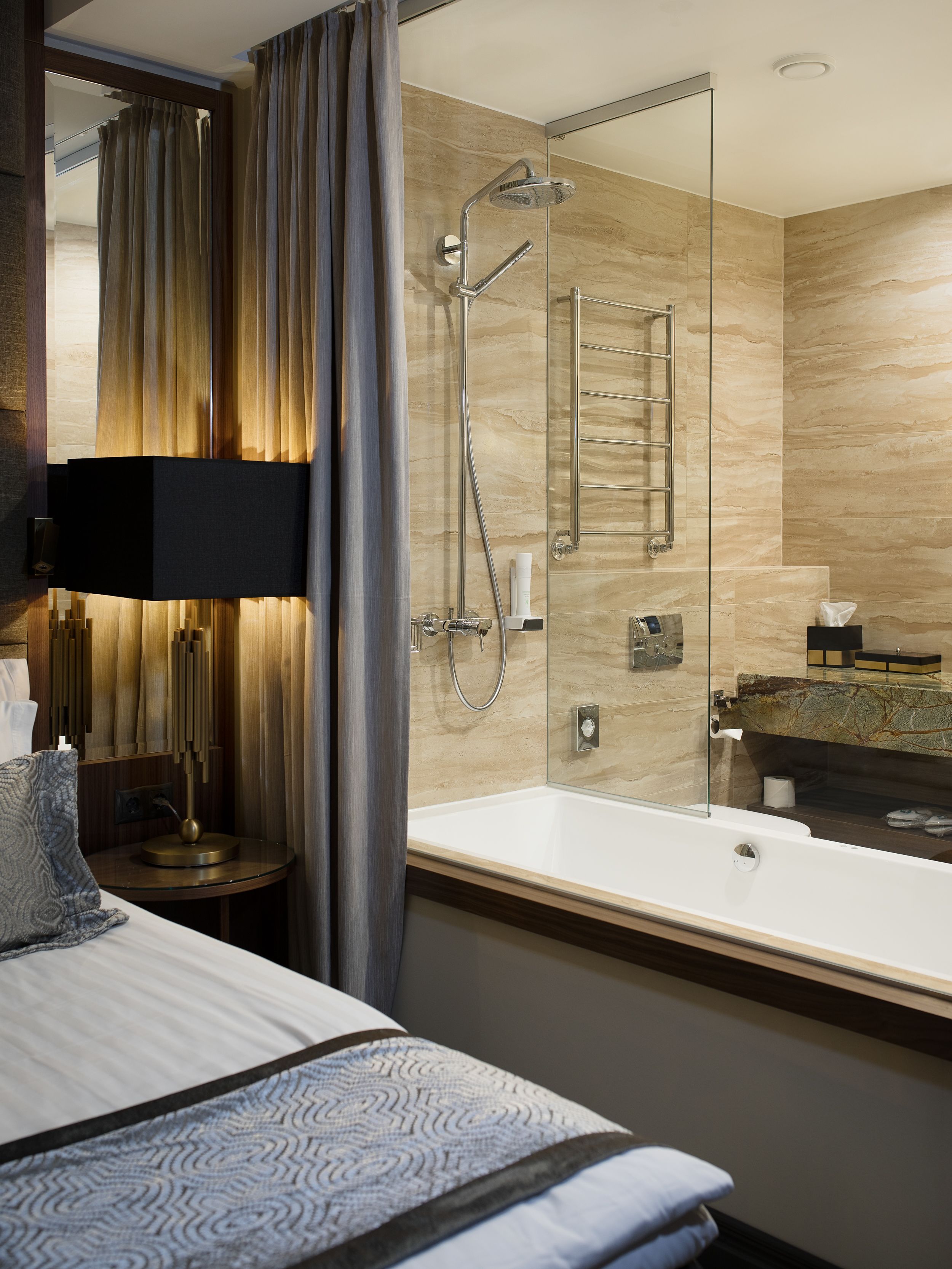 Un baño moderno con ducha de vidrio, una bañera grande y un tocador con espejo.