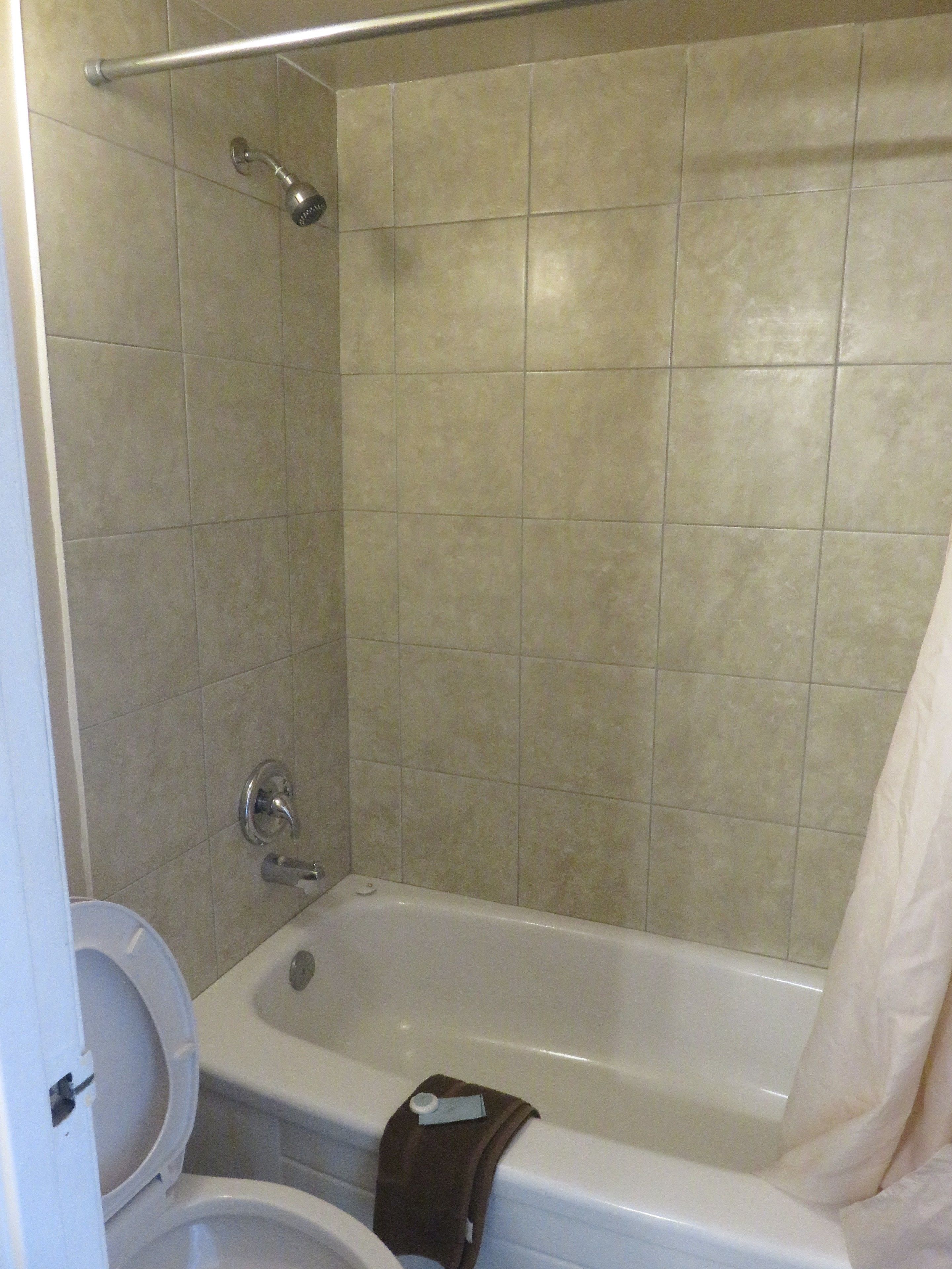 A bathroom with a bathtub, toilet, and shower.