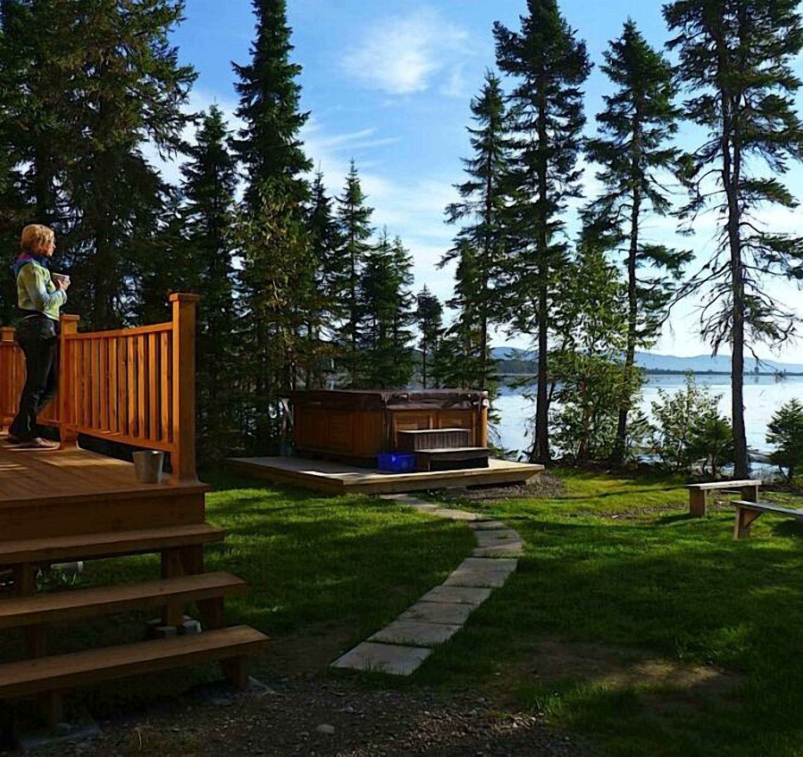 Una terraza con vistas a un lago y un bosque.