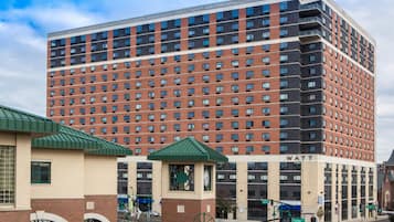 A multi-story building with a brick facade and a flat roof.