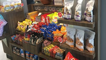 A snack display with various brands and types of chips and snacks.