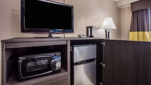 A compact kitchenette with a flat-screen TV, microwave, and refrigerator. - Baymont by Wyndham Appleton (Appleton)