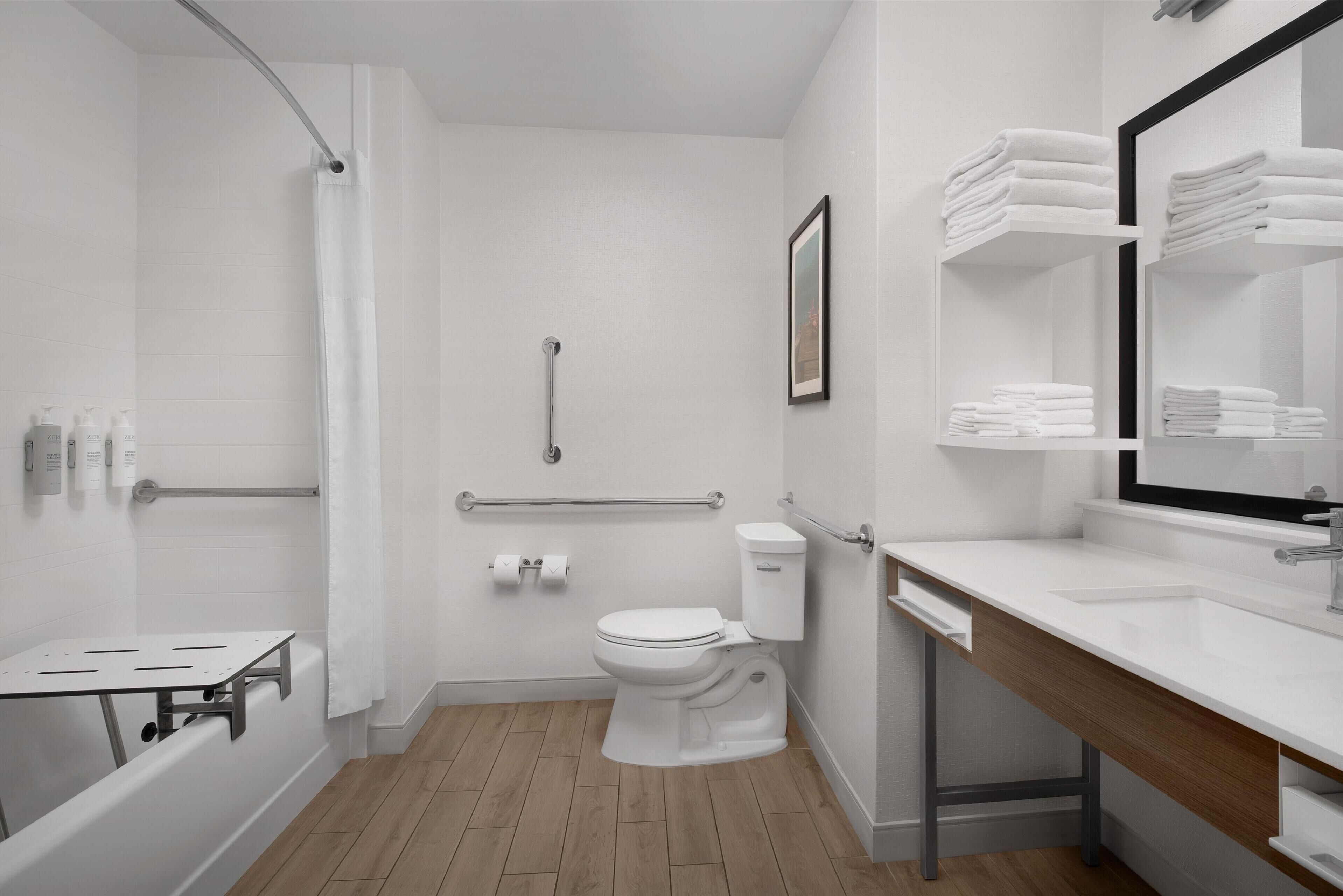 A modern bathroom with a shower, toilet, and sink.