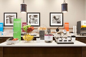 A breakfast buffet with various food items and a coffee station.