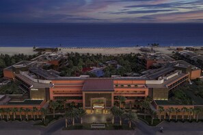 A hotel with a central entrance, multiple floors, and a beach view. - Hilton Cabo Verde Sal Resort (Sal)