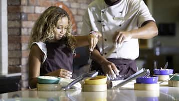 A person preparing food with bowls and utensils on a table.