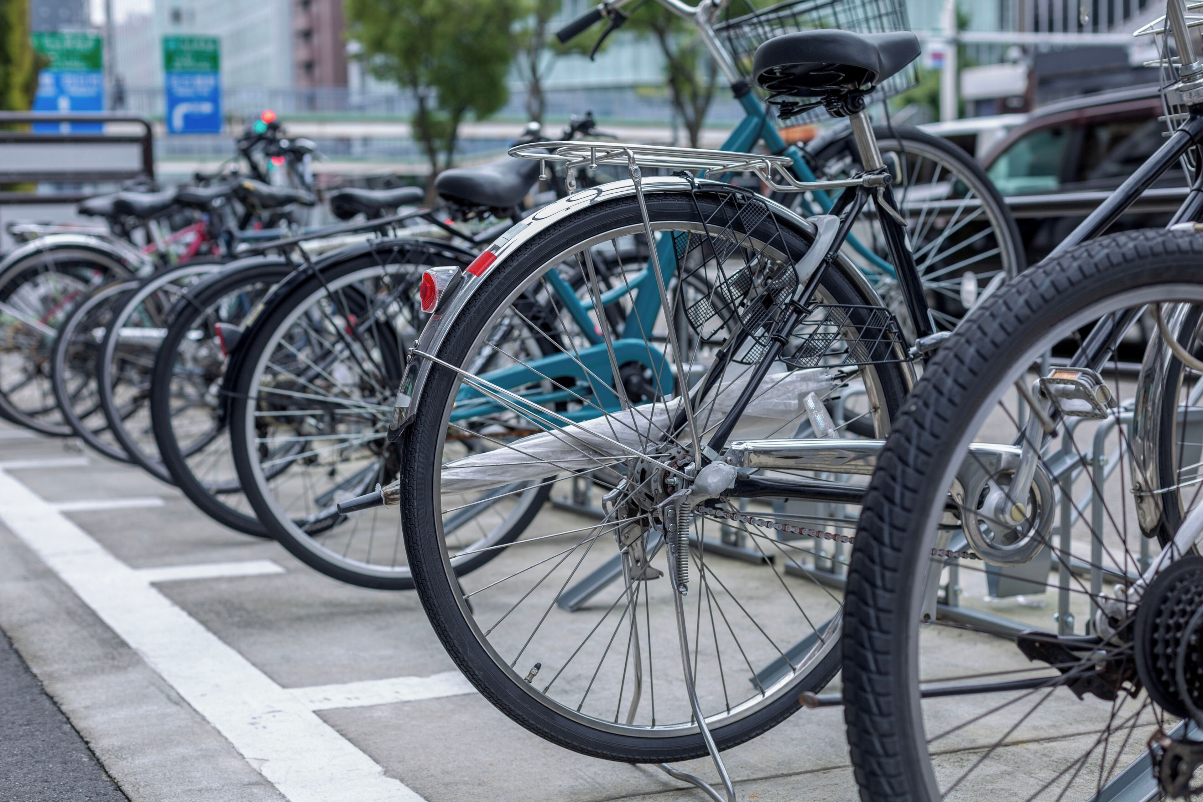 A row of bicycles parked in a designated bike rack area.