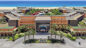 A modern hotel with a central entrance, multiple wings, and a pool area. - Hilton Cabo Verde Sal Resort (Sal)