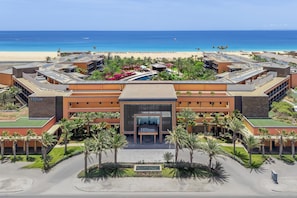 A modern hotel with a central entrance, multiple wings, and a pool area. - Hilton Cabo Verde Sal Resort (Sal)