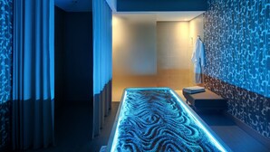 A modern spa area with a heated floor, a bench, and a towel rack. - Hilton Cabo Verde Sal Resort (Sal)