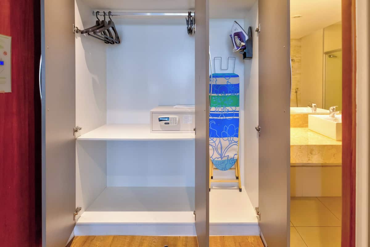 A bathroom with a shower, a toilet, and a sink.