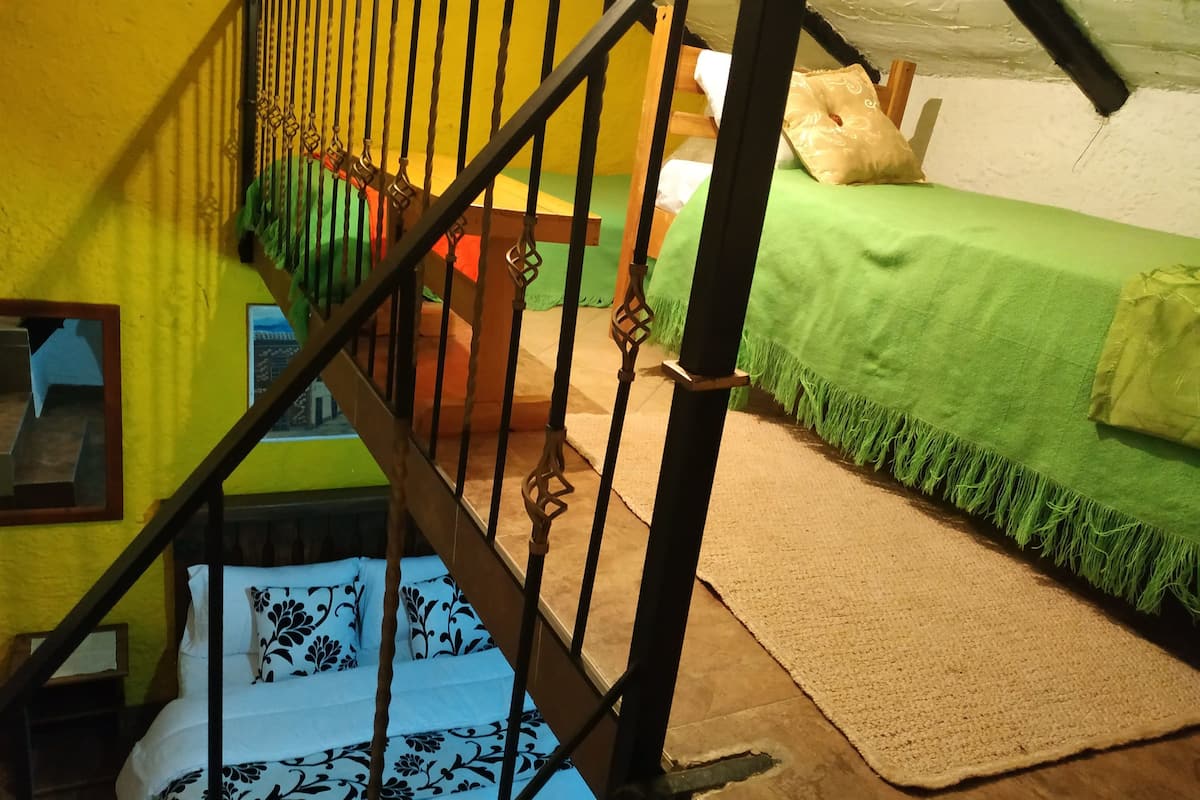 Habitación cuádruple estándar, varias camas, chimenea, vista al jardín | Ropa de cama