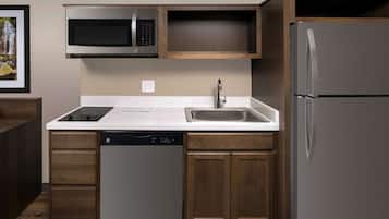 Full-size fridge, microwave, stovetop, cookware/dishes/utensils