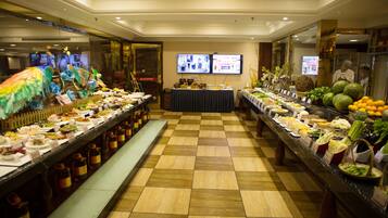 A buffet with various food items and a checkered floor.
