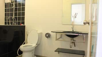 Un baño con inodoro, lavabo y ducha.