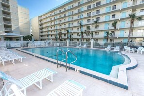 Outdoor pool, pool umbrellas, sun loungers - Sandcastles - Cocoa Beach Oceanfront Condos with Heated Pool Tennis Pet-Friendly (Cocoa Beach)