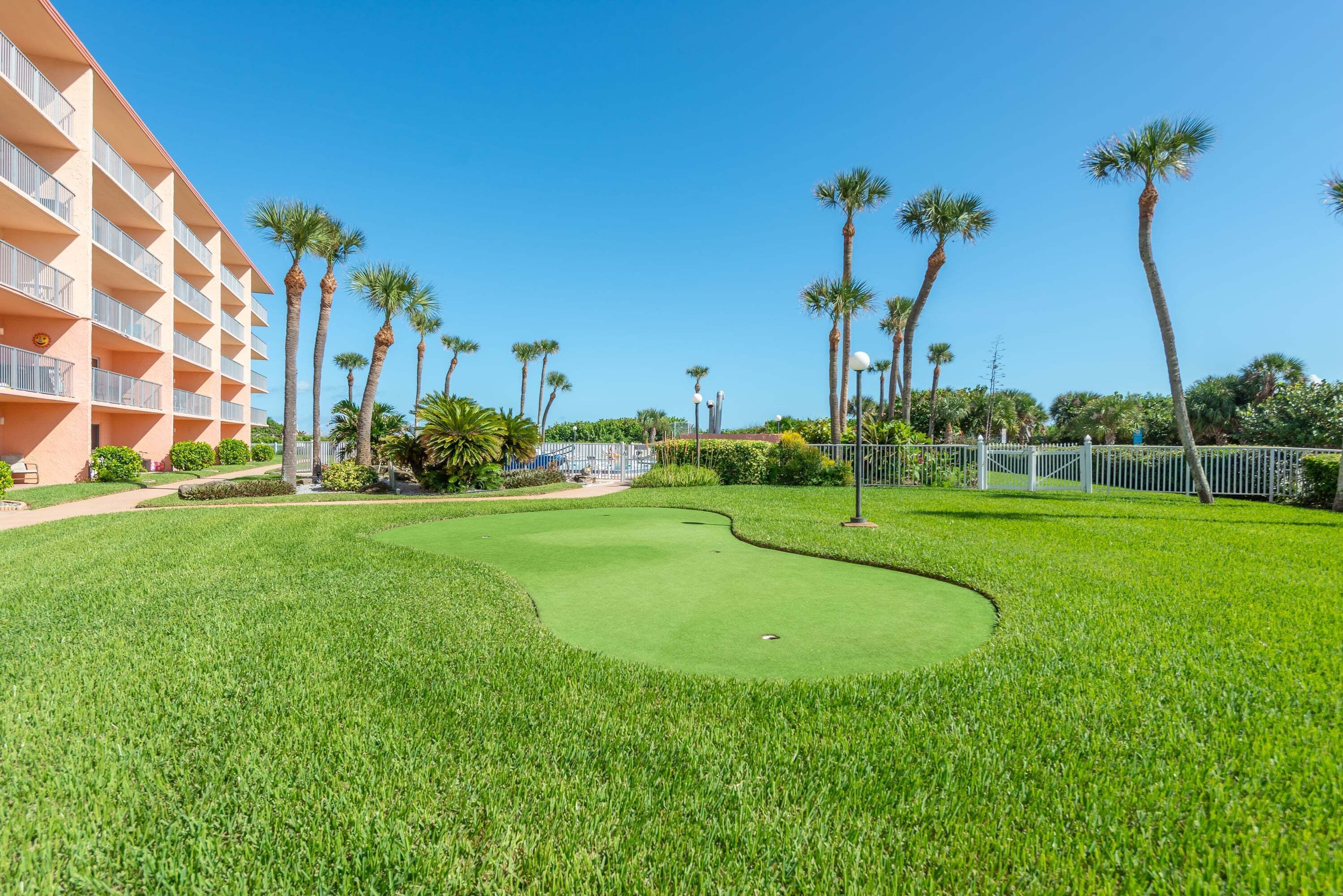 A golf course with a building on one side.