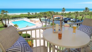 A balcony with a pool, beach view, and outdoor seating. - Canaveral Towers - Oceanfront Condos with Pool and Mini Golf by Port Canaveral - Cocoa Beach (Cape Canaveral)