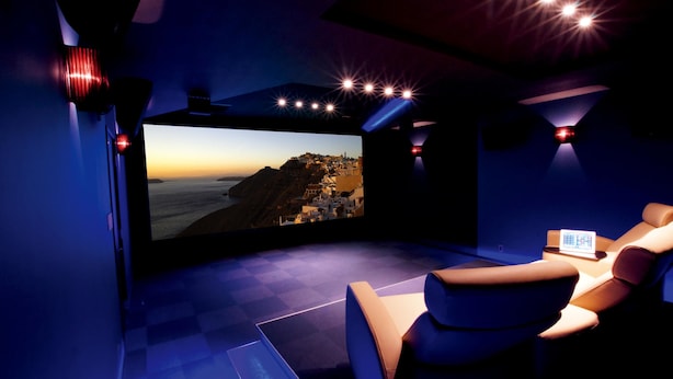A home theater with a large screen, comfortable seating, and ambient lighting. - The Wonder At Stay -bentencho- (Osaka)