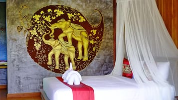 Una cama con dosel, un mural decorativo en la pared y un peluche sobre la cama.