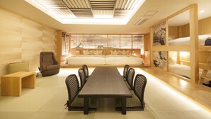 A modern room with a long table, chairs, a sofa, and a bed. - The Centurion Hotel Classic Akasaka (Tokyo)