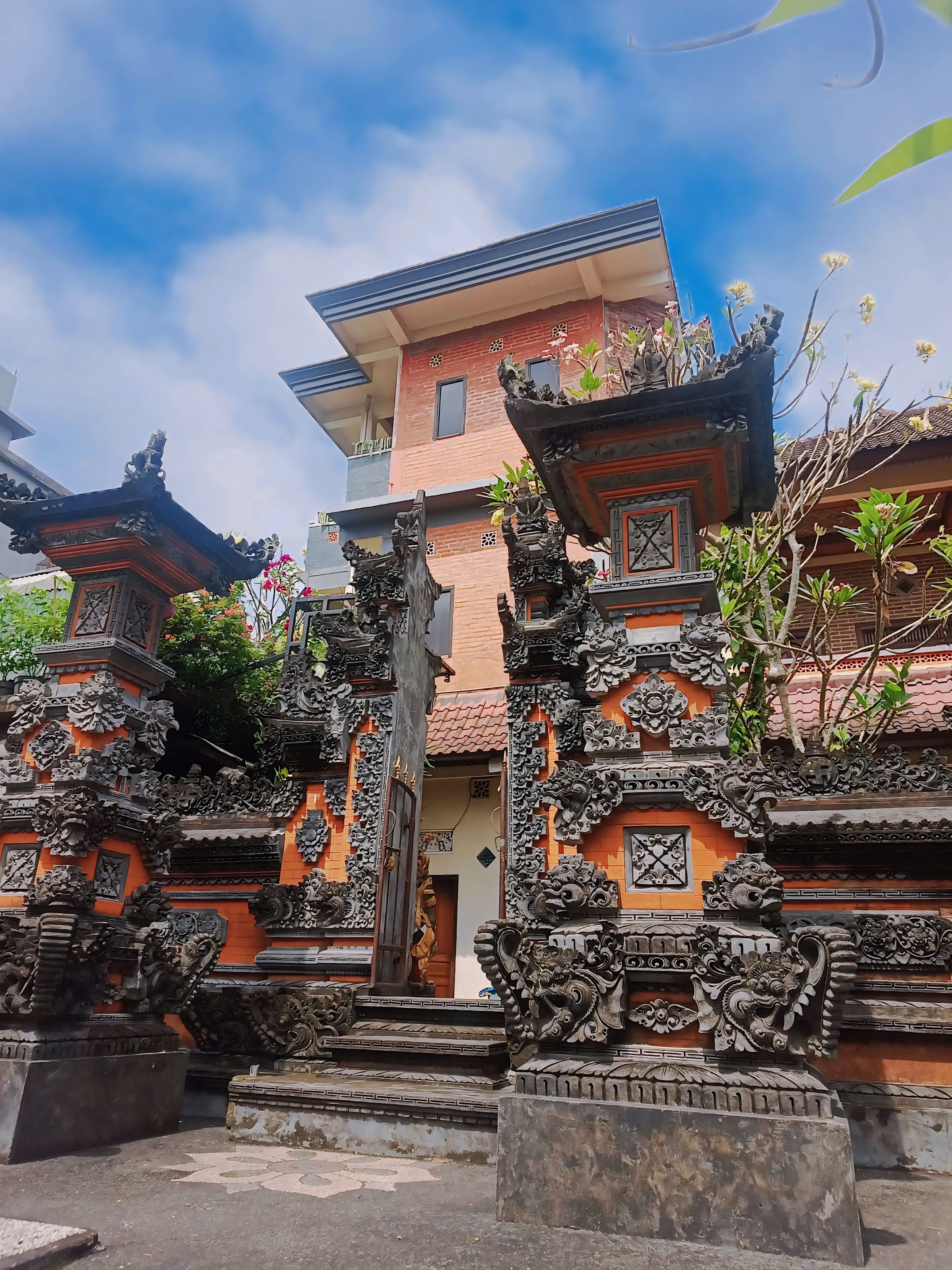 A traditional Balinese temple with ornate carvings and a central doorway.
