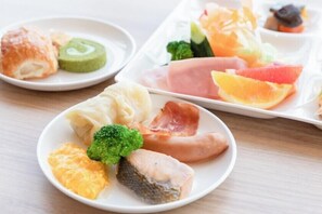 A variety of food items on plates, including fish, vegetables, and fruits. - Livemax Resort Hakone Ashinoko (Hakone)