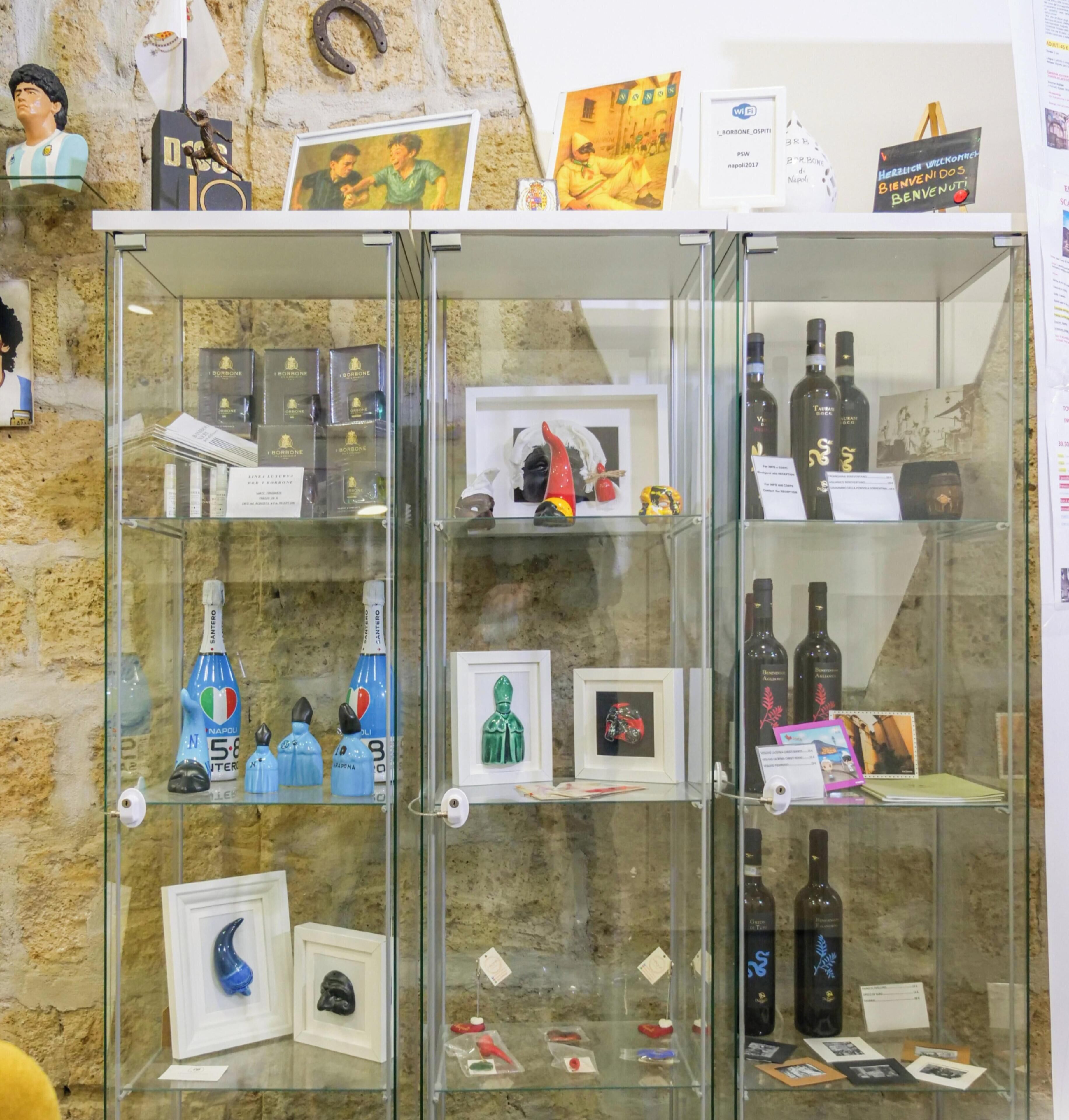 A display case with various items including framed pictures, bottles, and figurines.