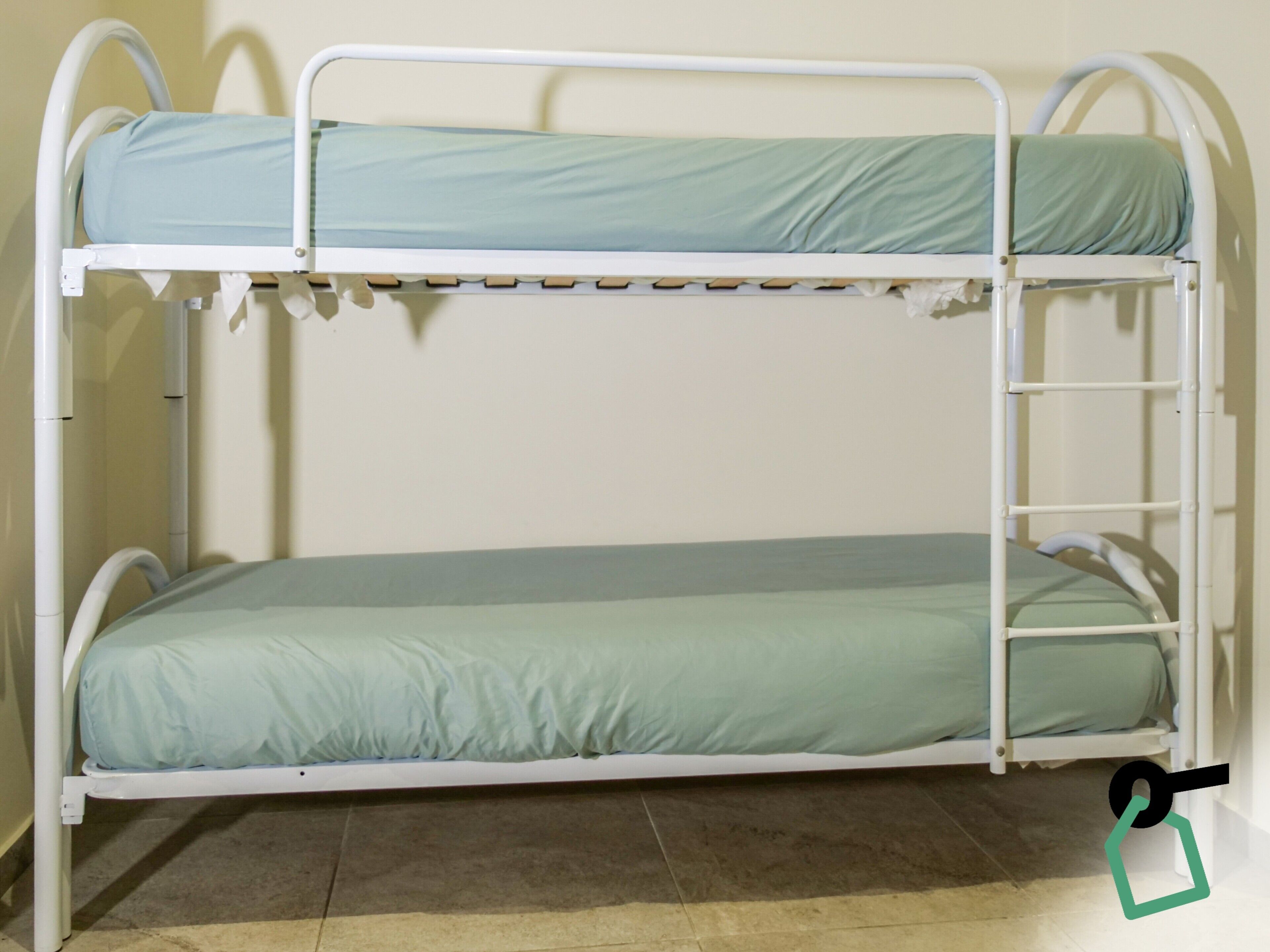 A bunk bed with two levels, each with a mattress and a headboard.