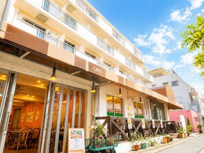 A multi-story building with a cafe on the ground floor. - Sakura Hotel Nippori (Tokyo)