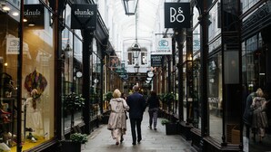 A narrow pedestrian street lined with shops and cafes, with people walking and sitting outside. - Hotel Indigo Cardiff by IHG (Cardiff)