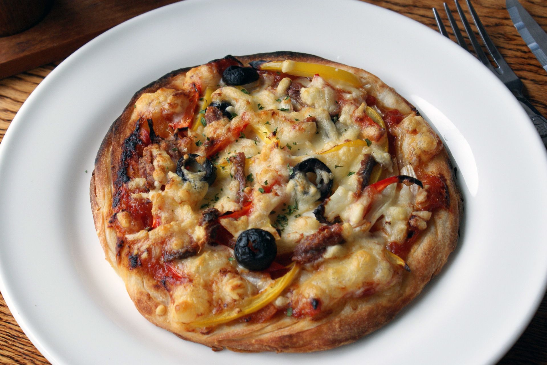A pizza on a white plate.