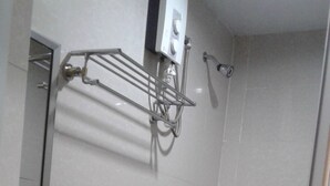 A bathroom with a toilet, sink, and a towel rack. - Asia Novo Boutique Hotel - Alaminos (Alaminos)