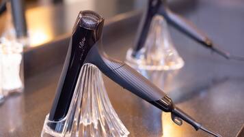 A close-up of a hair styling tool on a counter with a clear, reflective surface.