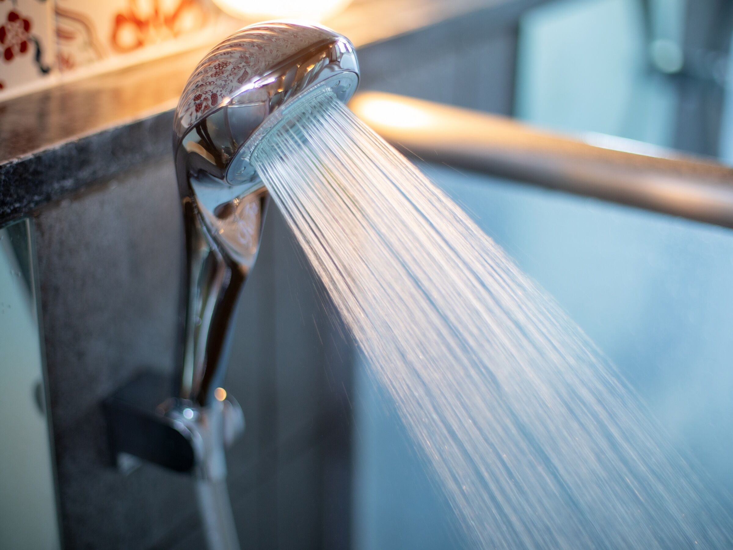 A showerhead with water flowing from it.