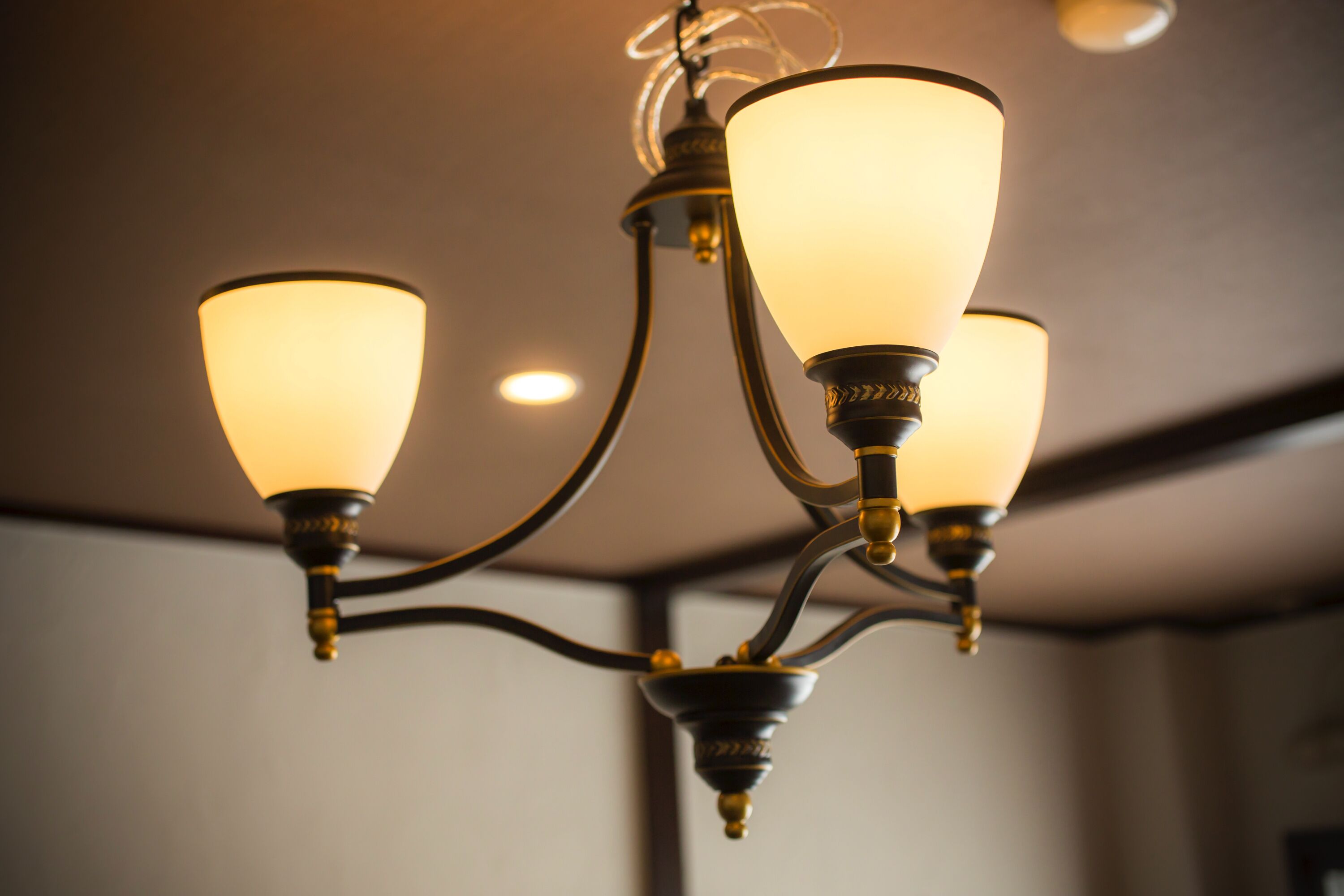 A chandelier with three light fixtures.