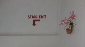 A staircase with a sign indicating the stair exit. - Asia Novo Boutique Hotel - Roxas (Roxas City)
