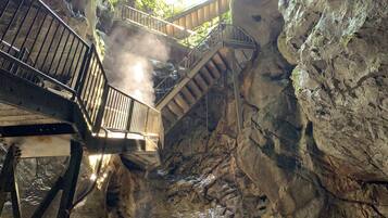 A cave with a staircase leading to a higher level.