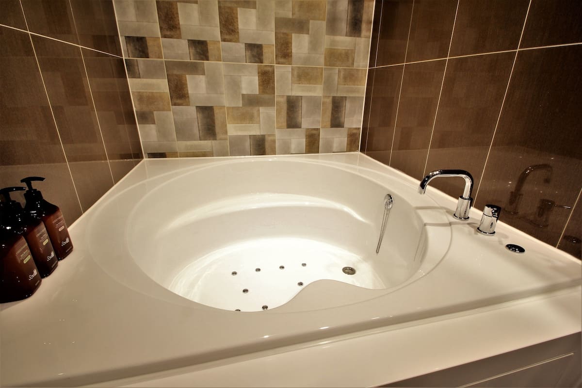 twin room | bathroom | separate bathtub and shower, designer toiletries, dressing gowns