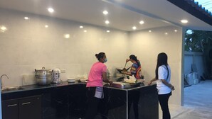 A modern kitchen with black marble countertops, stainless steel appliances, and a white tiled backsplash. - Royal Graces Pool Villas (Cha-am)