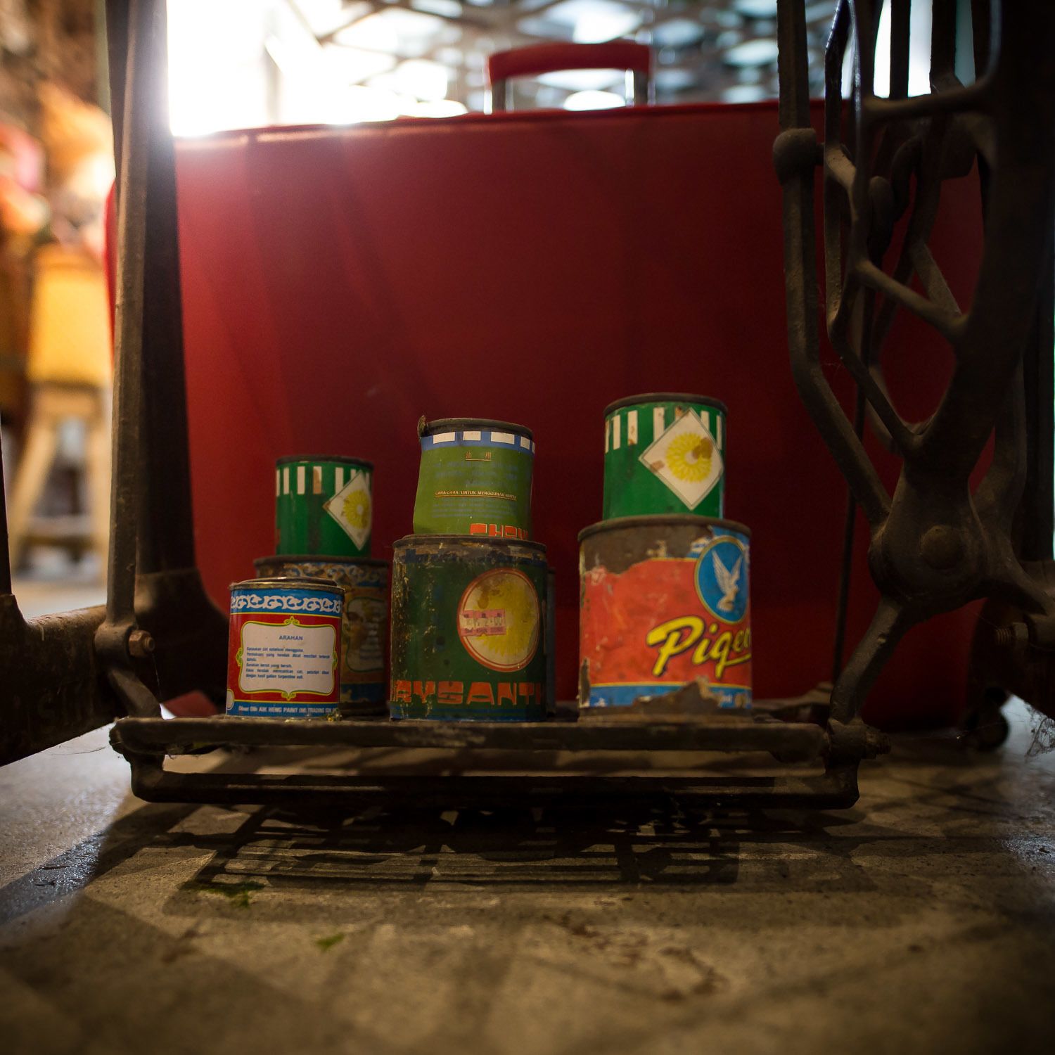 A collection of old, worn cans on a metal platform.