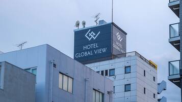 A modern hotel building with a prominent sign reading "HOTEL GLOBAL VIEW".