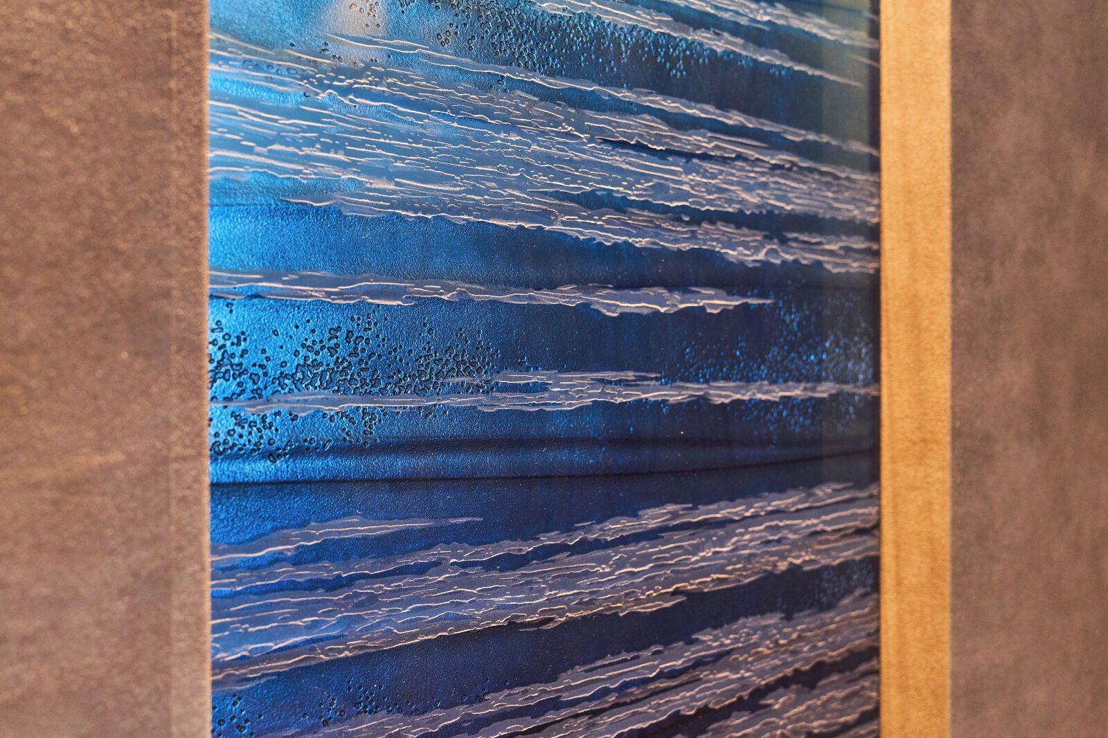 A textured wall with horizontal lines and bubbles.